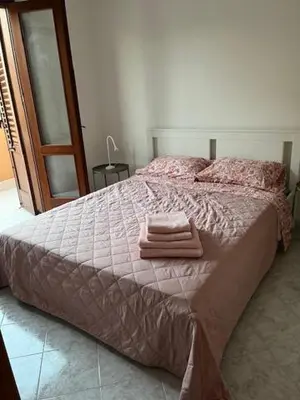 a bedroom with a bed with two towels on it at Casa Sole e Limone in Castellammare del Golfo