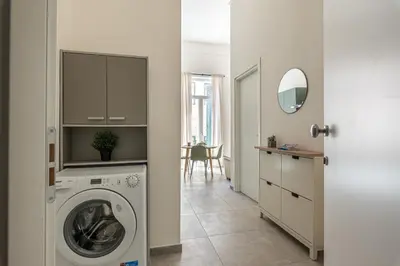 a laundry room with a washing machine and a mirror at Panurban Apartments by Wonderful Italy in Palermo