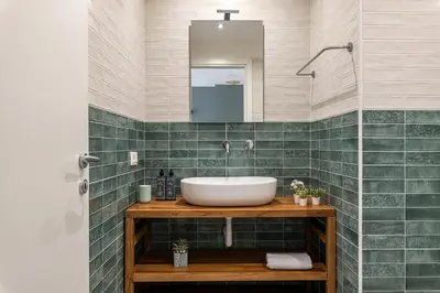 a bathroom with a sink and a mirror at Panurban Apartments by Wonderful Italy in Palermo