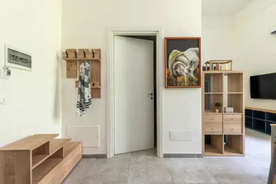 a living room with a door and a tv at Panurban Apartments by Wonderful Italy in Palermo