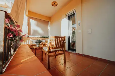 a living room with two chairs and a large window at Suite le palme in Aspra
