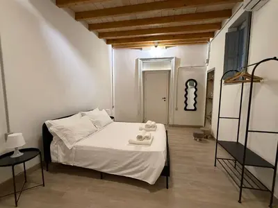 a bedroom with a bed with two towels on it at A al Quadrato in Palermo