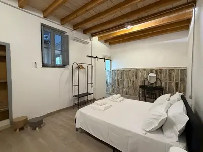 a bedroom with a white bed and a window at A al Quadrato in Palermo