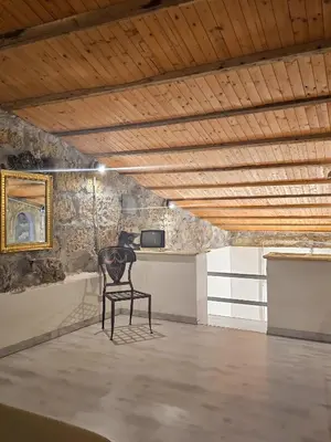 a chair sitting in a room with a desk at A al Quadrato in Palermo