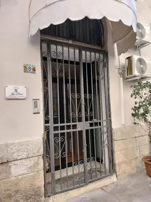 a door with a wrought iron gate on a building at Joy House in Palermo