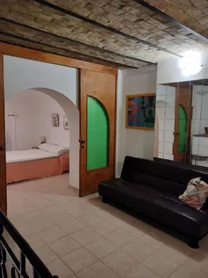 a living room with a couch and a bed at Joy House in Palermo