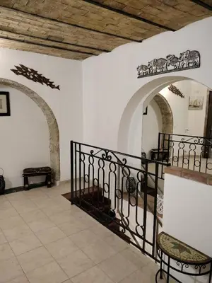 a room with a staircase in a building with archways at Joy House in Palermo