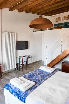 a bedroom with a bed with two towels on it at Santina Suites in Castellammare del Golfo