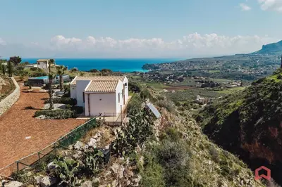 a large blue bed in a room with a window at Panoramic Villa with private Pool near Scopello in Scopello