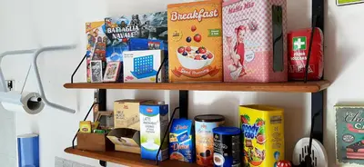 a shelf with food and cereal on it at B&B Porta Nuova in Palermo