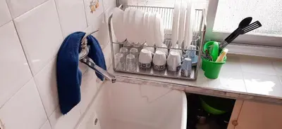a kitchen counter with a rack of utensils at B&B Porta Nuova in Palermo