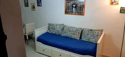 a bedroom with a bed with blue sheets and pillows at B&B Porta Nuova in Palermo