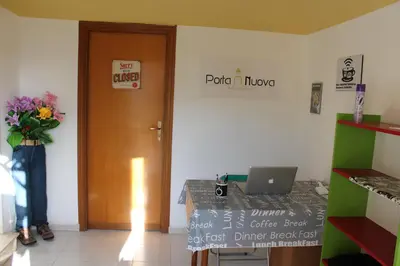 a room with a door and a table with a laptop at B&B Porta Nuova in Palermo