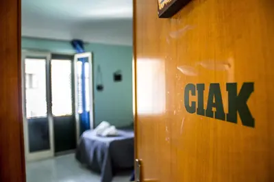 a room with a bed and a door with a sign on it at B&B Porta Nuova in Palermo
