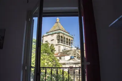 a view of a building from an open window at B&B Porta Nuova in Palermo