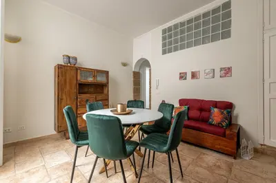 a living room with a table and chairs and a couch at Giudici Three Bedrooms Apartment by Wonderful Italy in Palermo