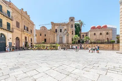 a group of people walking in a plaza in front of a building at Giudici Three Bedrooms Apartment by Wonderful Italy in Palermo
