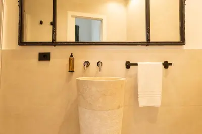 a bathroom with a marble sink and a mirror at Limes in Palermo