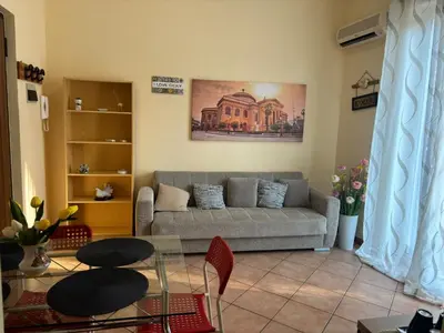 a living room with a couch and a glass table at Alessandra guesting house - Palermo in Palermo
