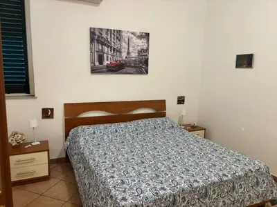 a bedroom with a bed and a picture on the wall at Alessandra guesting house - Palermo in Palermo