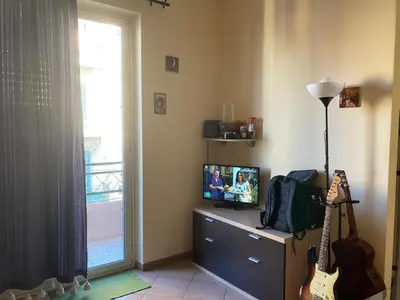 a living room with a guitar and a television at Alessandra guesting house - Palermo in Palermo