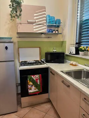 a kitchen with a stove top oven next to a sink at Alessandra guesting house - Palermo in Palermo