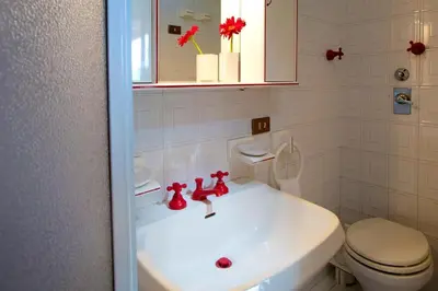 a bathroom with a white sink and a toilet at Poggio di mare in Castelluzzo