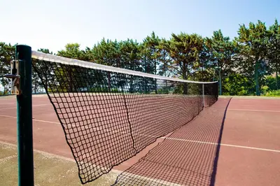 a tennis net on a tennis court at Poggio di mare in Castelluzzo