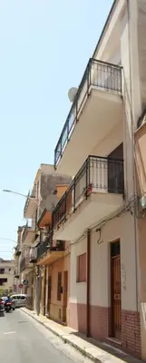 a building with a staircase on the side of a street at Appartamento La Rosa dei Venti in Porticello