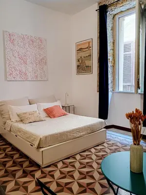a bedroom with a bed and a table at Campofranco Studio in Palermo