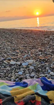 a beach with rocks and the sunset in the background at a due passi dal mare in Campofelice di Roccella