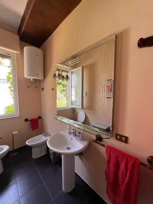 a bathroom with two sinks and a large mirror at La terrazza sul mare in Palermo