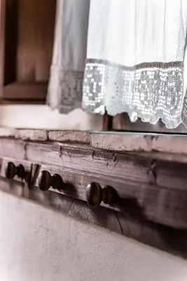 an old window with a curtain on a window sill at Casa Ninfee, immersa nel verde con piscina in comune in Terrasini