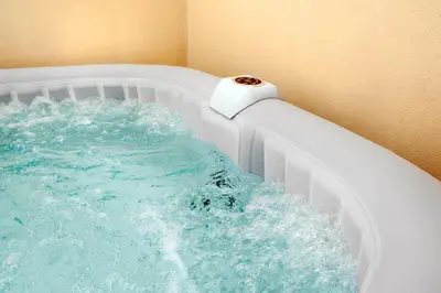 a bath tub filled with water with a pipe at Colonna Secret, Private Jacuzzi in Historic Center in Palermo