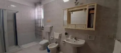 a bathroom with a sink and a toilet and a shower at Maria Isabella appartament in Isola delle Femmine