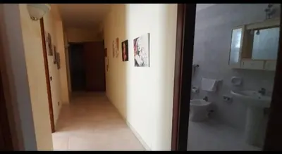 a hallway of a bathroom with a toilet and a sink at Maria Isabella appartament in Isola delle Femmine