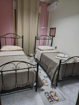 two beds sitting next to each other in a room at La casa di Anna e Lillo in Palermo
