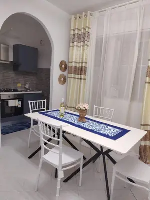 a white table and chairs in a kitchen at La casa di Anna e Lillo in Palermo