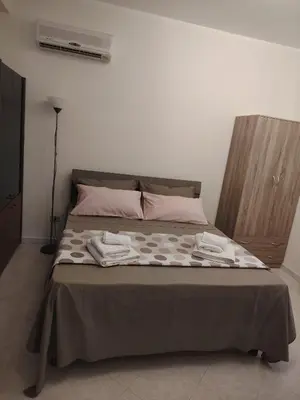 a bed with two towels on it in a bedroom at La casa di Anna e Lillo in Palermo