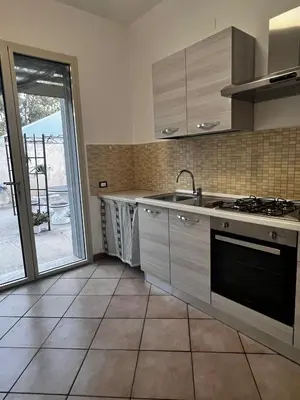 a kitchen with a sink and a stove at West Sicily Beach in Balestrate