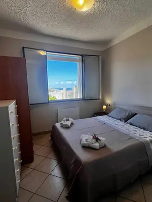 a bedroom with a large bed with towels on it at West Sicily Beach in Balestrate
