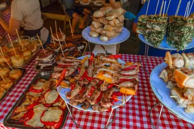 a table with plates of food on a red checked table cloth at La casettina di Dante in Palermo