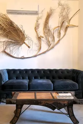 a living room with a black couch and a wooden table at zaraholiday24 in Palermo