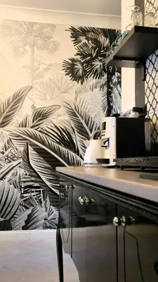 a kitchen with a mural of palm trees on the wall at zaraholiday24 in Palermo