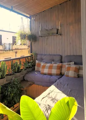 a room with a bed and a couch on a balcony at zaraholiday24 in Palermo