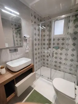 a bathroom with a shower and a toilet and a sink at Molly house in Palermo