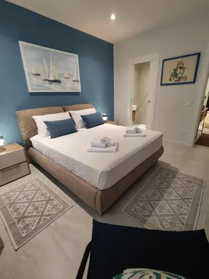 a bedroom with a large bed with blue walls at Molly house in Palermo