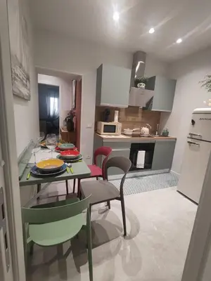 a kitchen and dining room with a table and chairs at Molly house in Palermo