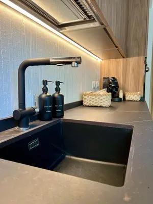 a kitchen sink with two bottles on top of it at Guardian Dream Suite House nel cuore di Palermo in Palermo