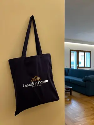 a black tote bag hanging on a wall at Guardian Dream Suite House nel cuore di Palermo in Palermo